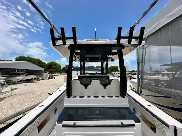  Yacht Photos Pics 2021 Streamline 35CC boat interior with rod holders and seating, under a clear blue sky.