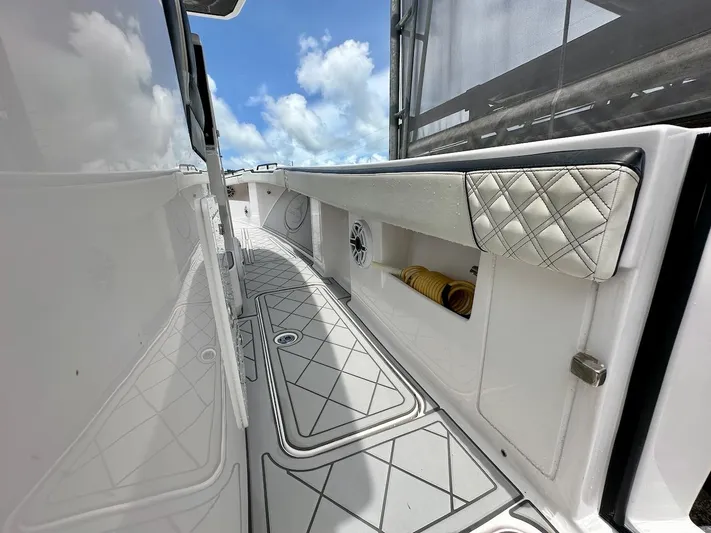  Yacht Photos Pics 2021 Streamline 35CC boat interior with quilted upholstery and storage compartments under a blue sky.