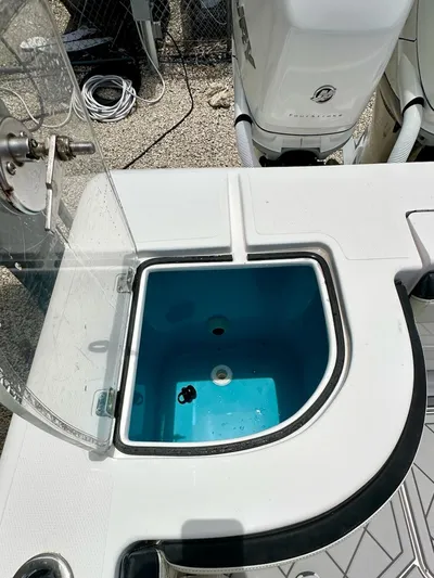  Yacht Photos Pics Open livewell on 2021 Streamline 35CC boat, showing interior and engine in background.