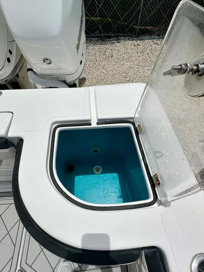  Yacht Photos Pics Open livewell on 2021 Streamline 35CC boat, showing interior and engine in background.