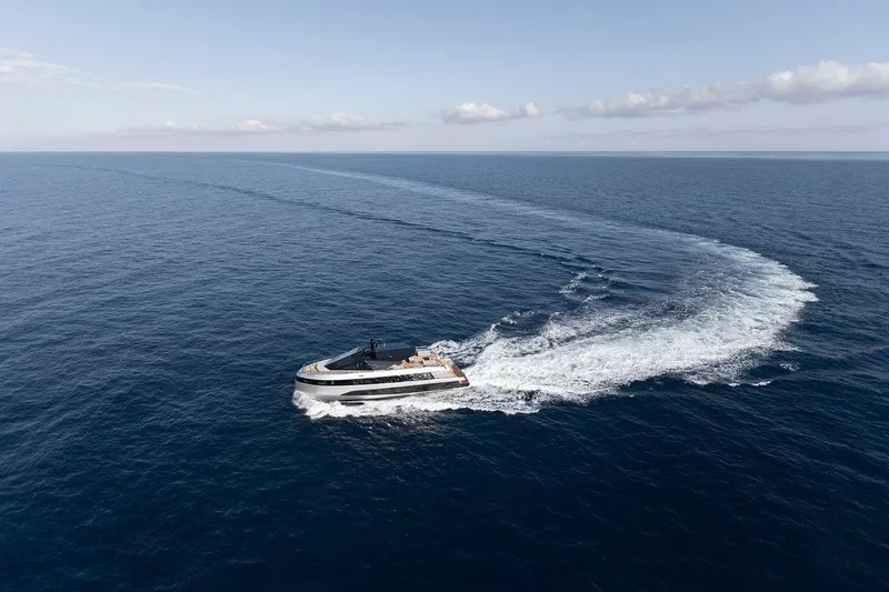 Carat Yacht Photos Pics 2024 WallyWhy200 yacht cruising on open sea, leaving a curved wake.