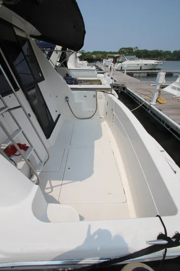  Yacht Photos Pics 1996 Bayliner 3988 Command Bridge Motoryacht docked, showcasing spacious deck and sleek design.