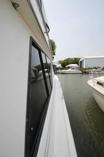  Yacht Photos Pics 1996 Bayliner 3988 Command Bridge Motoryacht docked in a marina.