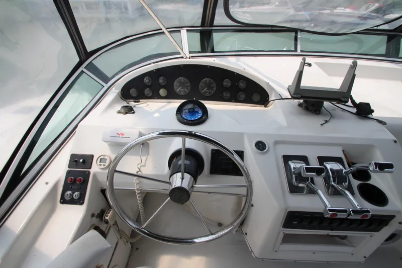  Yacht Photos Pics 1996 Bayliner 3988 Command Bridge Motoryacht helm with steering wheel and control panel.