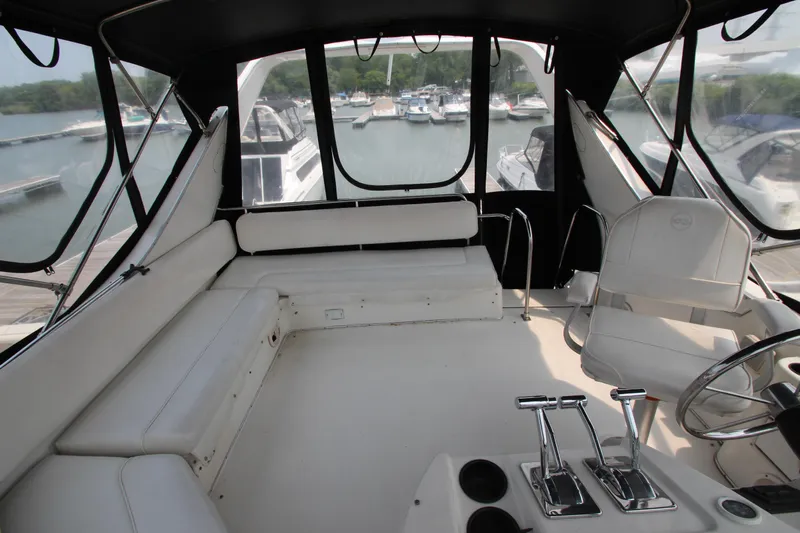  Yacht Photos Pics 1996 Bayliner 3988 Command Bridge Motoryacht interior with helm, seating, and marina view.