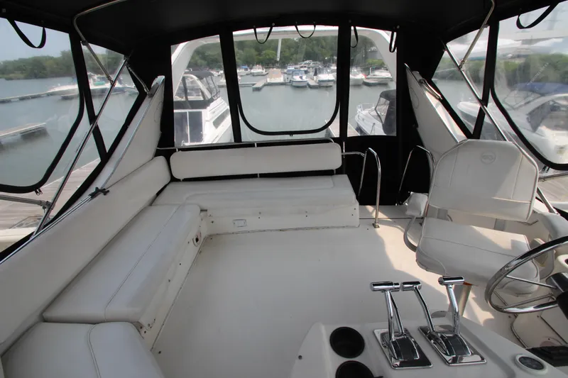  Yacht Photos Pics 1996 Bayliner 3988 Command Bridge Motoryacht interior with white seating and helm controls.