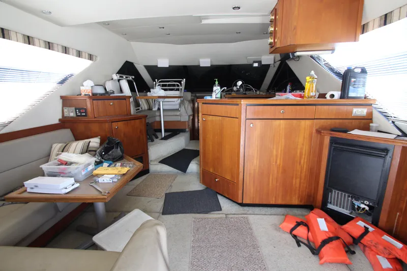  Yacht Photos Pics Interior of 1996 Bayliner 3988 Command Bridge Motoryacht with wood cabinetry and seating area.