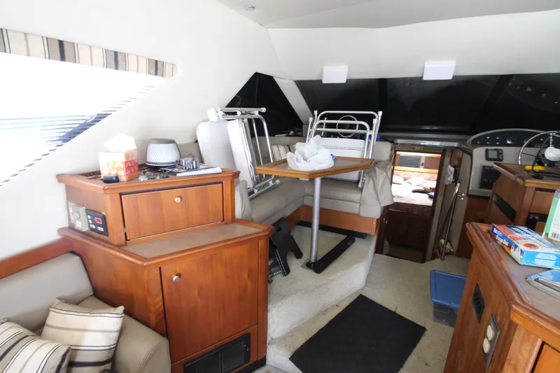  Yacht Photos Pics Interior of 1996 Bayliner 3988 Command Bridge Motoryacht with wooden cabinetry and seating area.
