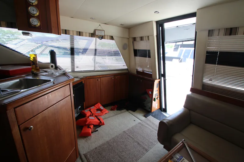  Yacht Photos Pics Interior of 1996 Bayliner 3988 Command Bridge Motoryacht with kitchen and seating area.