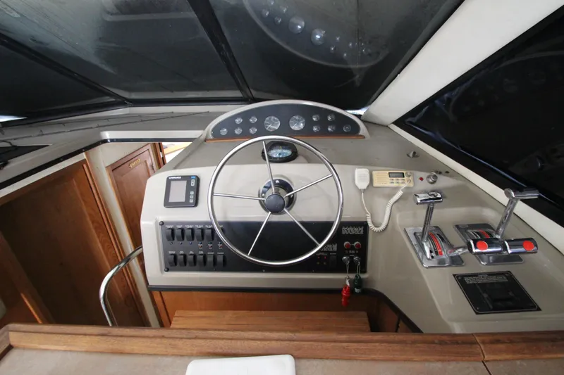 Yacht Photos Pics Helm of 1996 Bayliner 3988 Command Bridge Motoryacht with steering wheel and controls.