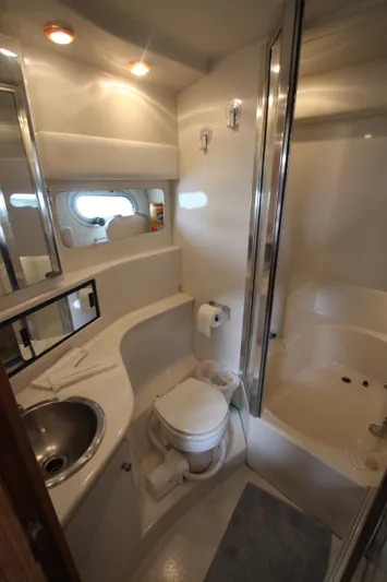  Yacht Photos Pics Bathroom interior of 1996 Bayliner 3988 Command Bridge Motoryacht, featuring sink, toilet, and shower.