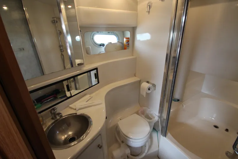  Yacht Photos Pics Bathroom interior of 1996 Bayliner 3988 Command Bridge Motoryacht, featuring sink, toilet, and shower.
