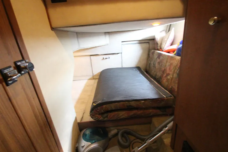  Yacht Photos Pics 1996 Bayliner 3988 Command Bridge Motoryacht interior cabin with bed and storage.