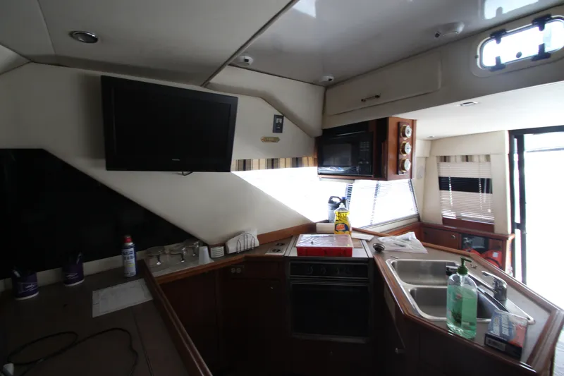  Yacht Photos Pics Interior of 1996 Bayliner 3988 Command Bridge Motoryacht kitchen with appliances and sink.