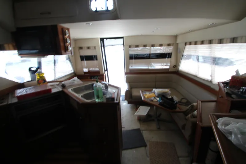  Yacht Photos Pics Interior of 1996 Bayliner 3988 Command Bridge Motoryacht with kitchen and seating area.