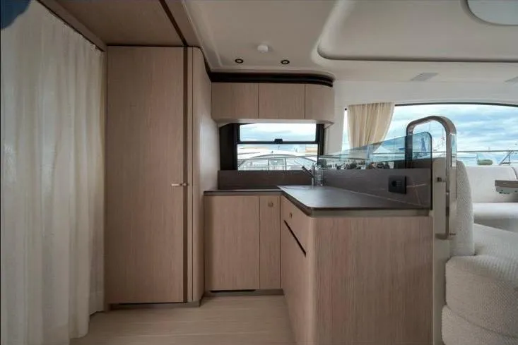 Pam Yacht Photos Pics Interior of 2023 Azimut Fly 53 yacht, featuring modern wood cabinetry and sleek design.