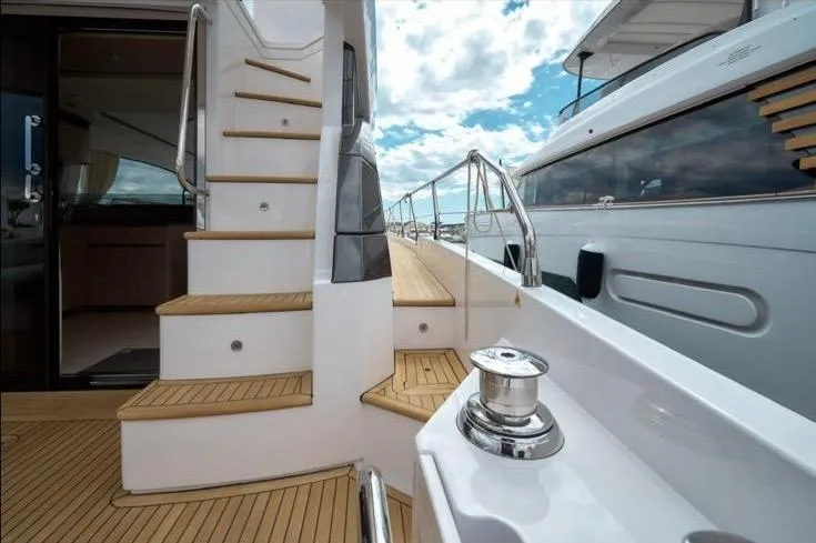 Pam Yacht Photos Pics 2023 Azimut Fly 53 yacht deck with wooden stairs and sleek design.