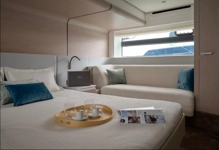 Pam Yacht Photos Pics Luxurious interior of 2023 Azimut Fly 53 yacht with cozy bed and elegant decor.