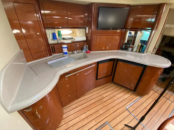 2 Life Yacht Photos Pics 2003 Sea Ray Sundancer yacht kitchen with wooden cabinets and modern appliances.