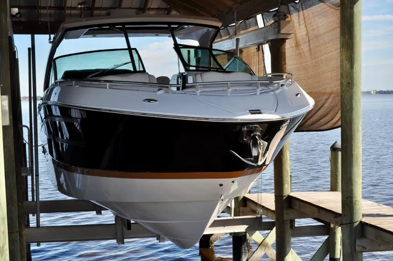  Yacht Photos Pics 2019 Four Winns H350 OB boat docked in a covered marina.