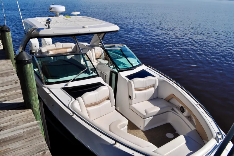  Yacht Photos Pics 2019 Four Winns H350 OB boat docked on calm water, featuring spacious seating.
