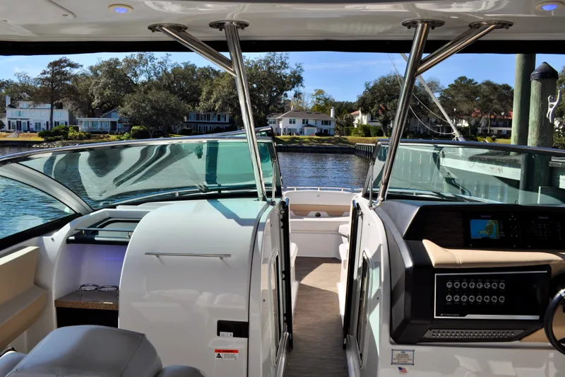  Yacht Photos Pics 2019 Four Winns H350 OB boat interior with waterfront view, featuring modern dashboard and seating.