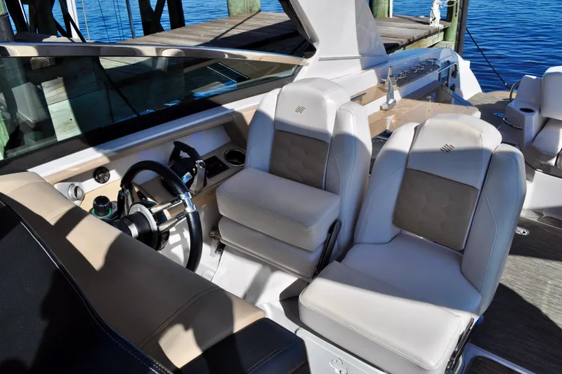  Yacht Photos Pics 2019 Four Winns H350 OB boat interior with luxurious seating and steering wheel.