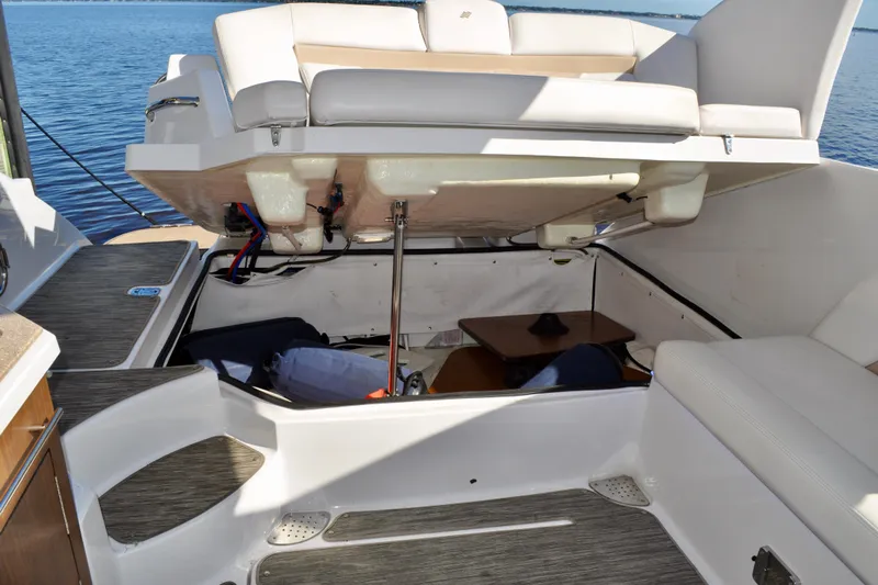  Yacht Photos Pics 2019 Four Winns H350 OB boat with open storage compartment, revealing interior details.
