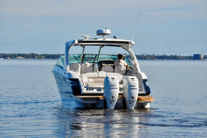  Yacht Photos Pics 2019 Four Winns H350 OB boat cruising on calm water, rear view.