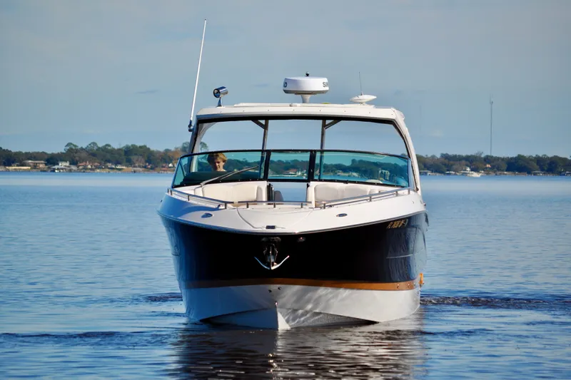  Yacht Photos Pics 2019 Four Winns H350 OB boat cruising on a calm lake.