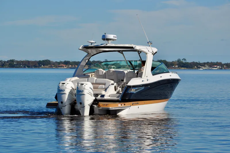  Yacht Photos Pics 2019 Four Winns H350 OB boat on calm water, featuring dual outboard engines.