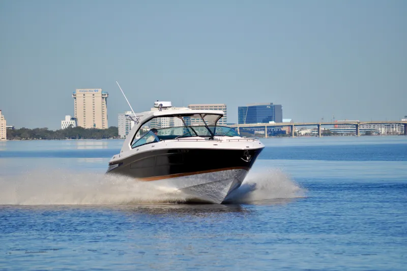  Yacht Photos Pics 2019 Four Winns H350 OB cruising on a calm urban waterway.