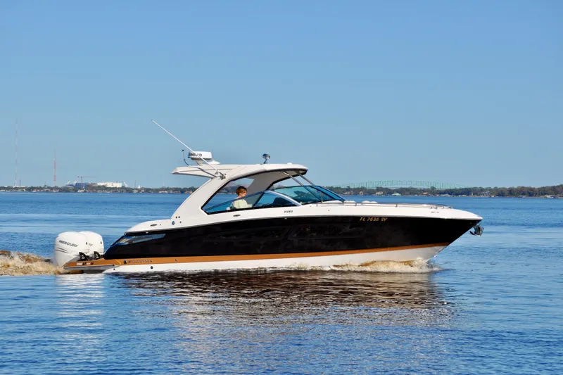  Yacht Photos Pics 2019 Four Winns H350 OB boat cruising on a calm lake.