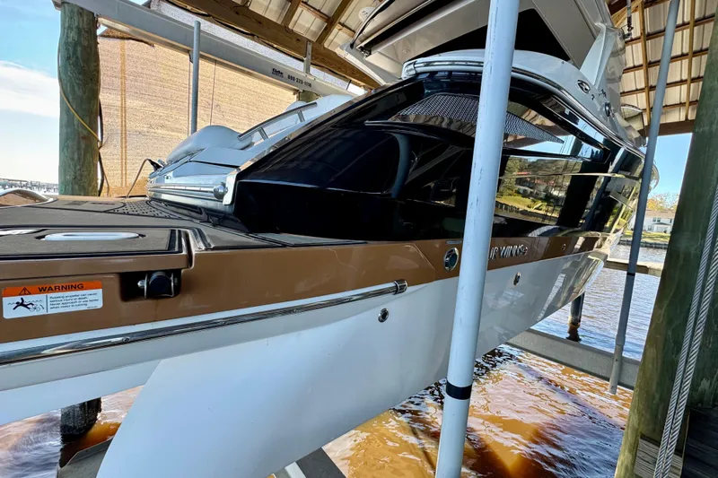  Yacht Photos Pics 2019 Four Winns H350 OB boat docked under a covered structure.