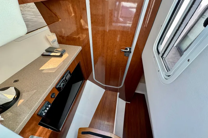  Yacht Photos Pics 2019 Four Winns H350 OB cabin interior with wood finish and countertop.