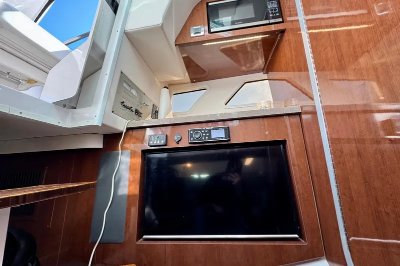  Yacht Photos Pics Interior of 2019 Four Winns H350 OB boat with TV, microwave, and control panel.