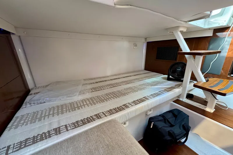  Yacht Photos Pics 2019 Four Winns H350 OB cabin interior with bed, stairs, and fan.