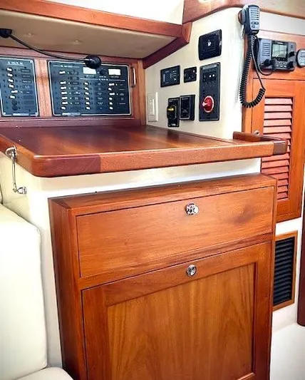 Last Dance Yacht Photos Pics 2019 Pacific Seacraft 31 interior with control panels and wooden cabinetry.