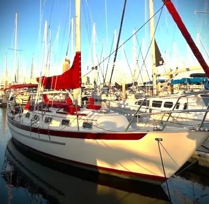 Last Dance Yacht Photos Pics 2019 Pacific Seacraft 31 sailboat with red accents docked in a marina.