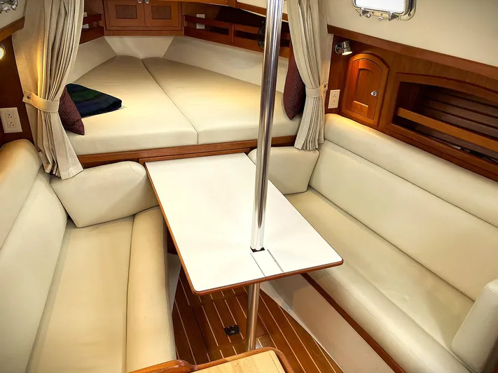Last Dance Yacht Photos Pics Interior of 2019 Pacific Seacraft 31 sailboat with cozy seating and wooden accents.