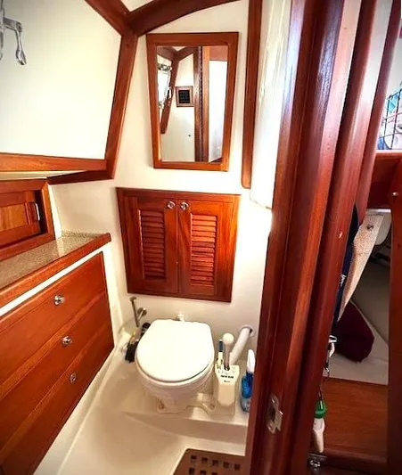 Last Dance Yacht Photos Pics 2019 Pacific Seacraft 31 yacht bathroom with wooden cabinetry and modern fixtures.
