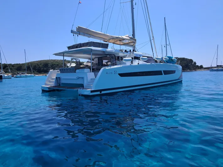  Yacht Photos Pics 2025 Fountaine Pajot Catamaran Aura 51 sailing in clear blue waters.