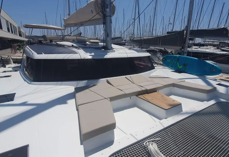  Yacht Photos Pics 2025 Fountaine Pajot Catamaran Aura 51 docked, featuring spacious deck and modern design.