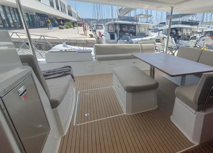  Yacht Photos Pics Spacious deck of 2025 Fountaine Pajot Catamaran Aura 51 with seating and table.