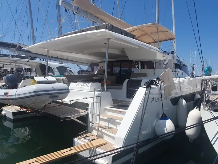  Yacht Photos Pics 2025 Fountaine Pajot Catamaran Aura 51 docked, featuring spacious deck and modern design.