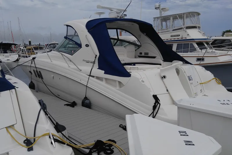  Yacht Photos Pics 2011 Sea Ray 390 Sundancer yacht docked at marina, featuring sleek design and blue canopy.