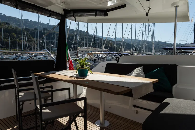 Twenty Cent Yacht Photos Pics Luxurious Lagoon 46 yacht interior with dining area, marina view, and elegant decor, 2021 model.