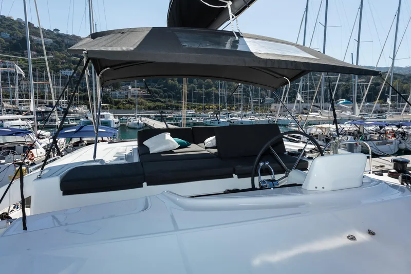 Twenty Cent Yacht Photos Pics 2021 Lagoon 46 yacht helm station with canopy in marina setting.