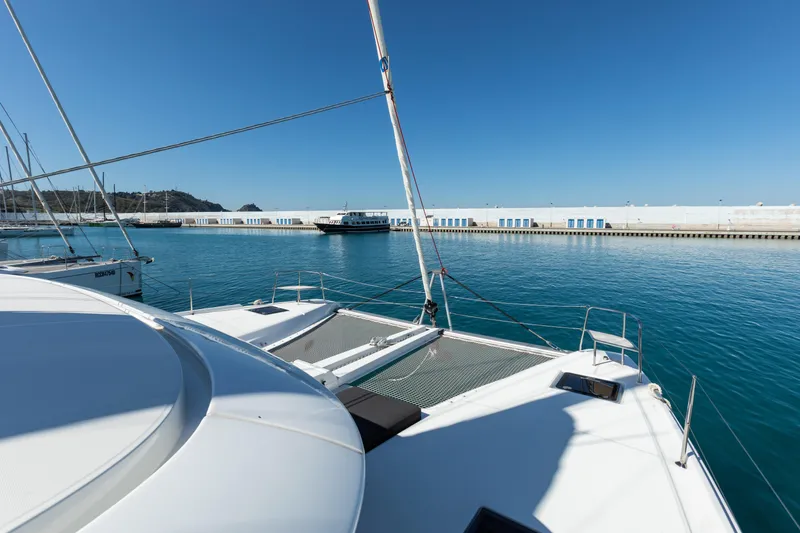 Twenty Cent Yacht Photos Pics 2021 Lagoon 46 catamaran docked in a sunny marina, clear blue sky.