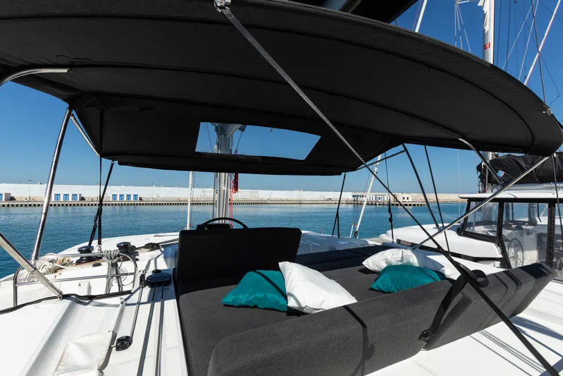 Twenty Cent Yacht Photos Pics Luxurious 2021 Lagoon 46 catamaran with shaded deck and comfortable seating in a marina.